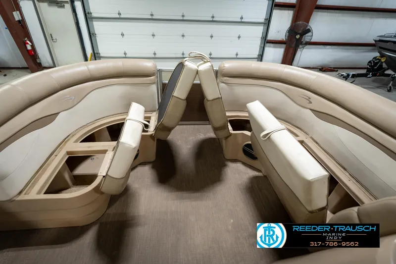 Slide: The Image of 2017 Bennington 18 SLX boat interior with beige seating and storage compartments. - 21