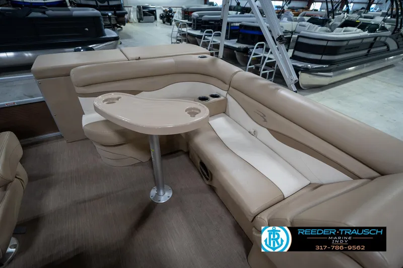 Slide: The Image of 2017 Bennington 18 SLX pontoon boat interior with beige seating and table. - 24
