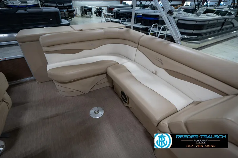 Slide: The Image of 2017 Bennington 18 SLX pontoon boat interior with beige seating in showroom. - 25