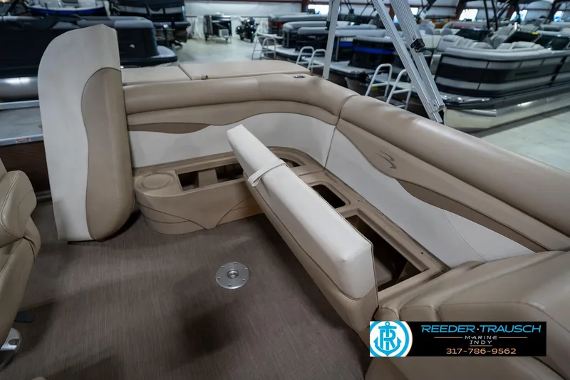 Slide: The Image of 2017 Bennington 18 SLX pontoon boat interior with beige seating and storage compartments. - 26