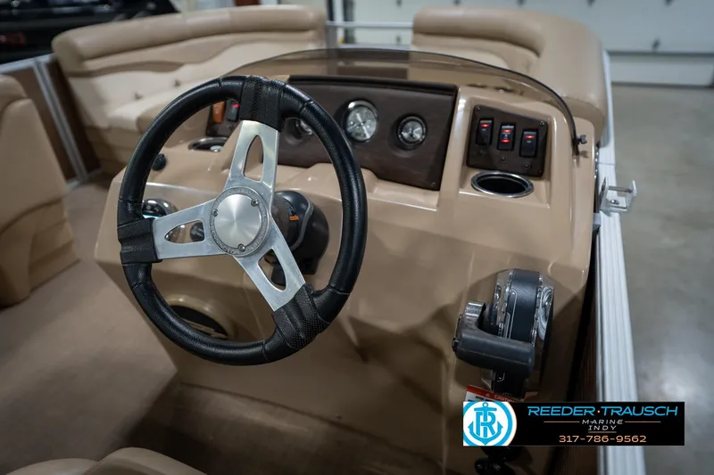 Slide: The Image of Steering console of a 2017 Bennington 18 SLX boat with controls and gauges. - 27