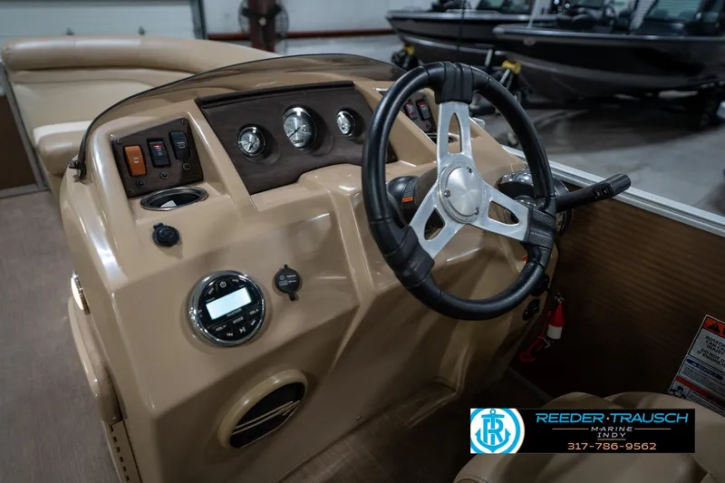 Slide: The Image of 2017 Bennington 18 SLX boat dashboard with steering wheel and controls. - 28
