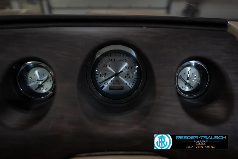 Slide: The Image of Dashboard gauges of a 2017 Bennington 18 SLX boat, featuring RPM and fuel indicators. - 32