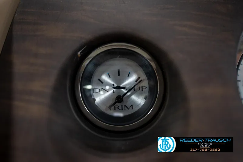 Slide: The Image of 2017 Bennington 18 SLX trim gauge on wooden dashboard, Reeder Trausch Marine logo. - 33
