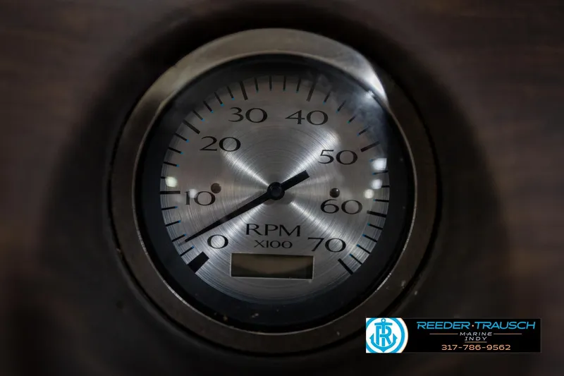 Slide: The Image of Close-up of a 2017 Bennington 18 SLX RPM gauge, showing Reeder-Trausch Marine logo. - 34