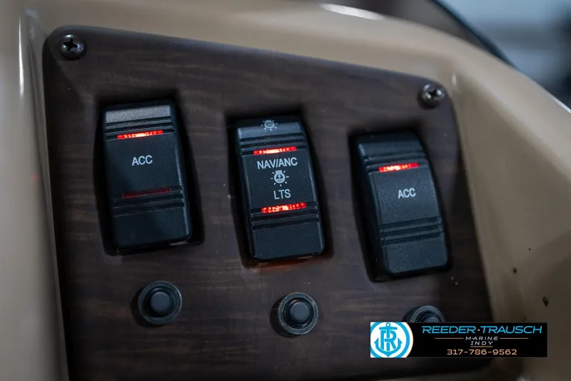 Slide: The Image of Control panel of a 2017 Bennington 18 SLX boat with illuminated switches. - 36