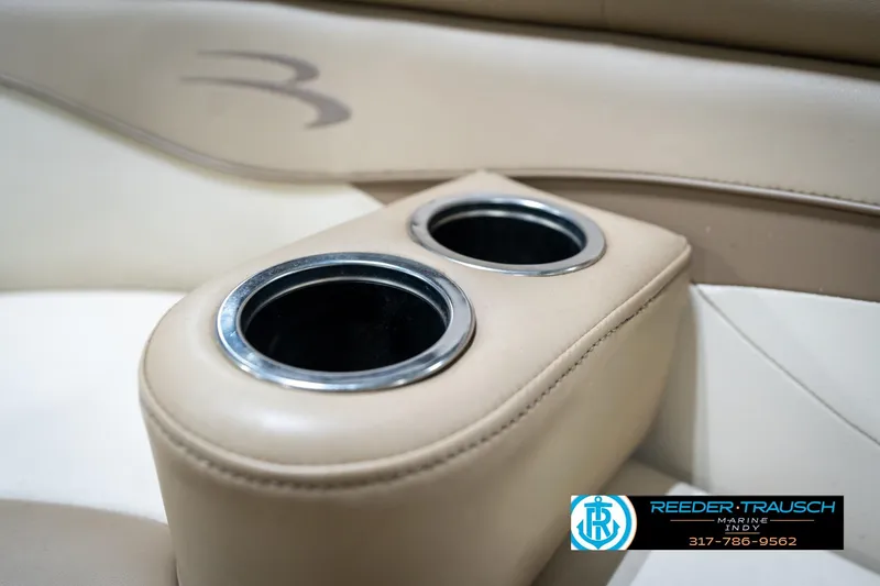 Slide: The Image of 2017 Bennington 18 SLX boat interior with dual cup holders and beige upholstery. - 44