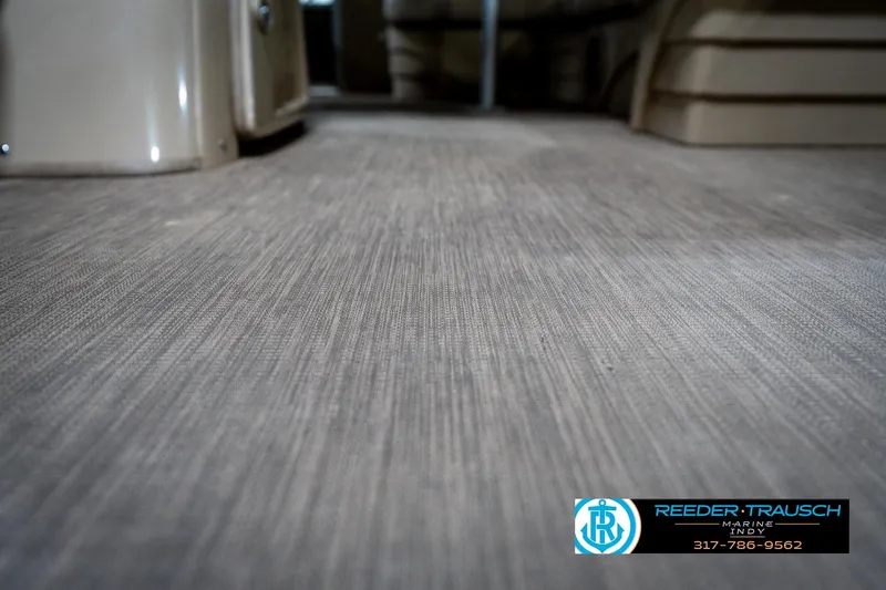 Slide: The Image of 2017 Bennington 18 SLX boat interior flooring, featuring textured design and Reeder Trausch Marine logo. - 46