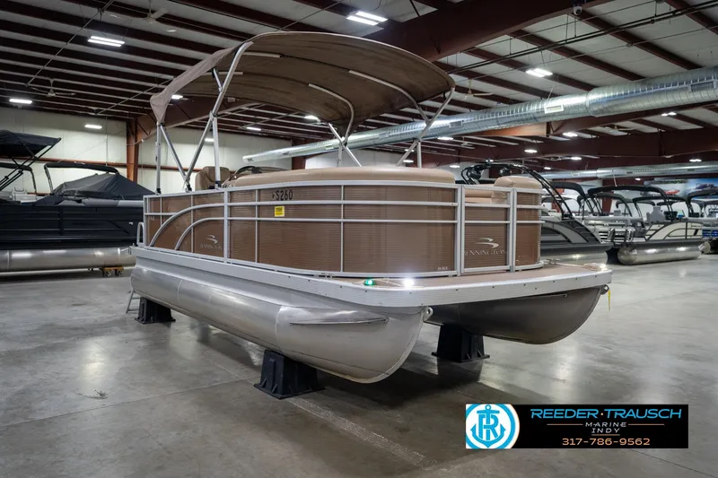 Slide: The Image of 2017 Bennington 18 SLX pontoon boat displayed indoors at Reeder-Trausch Marine showroom. - 5