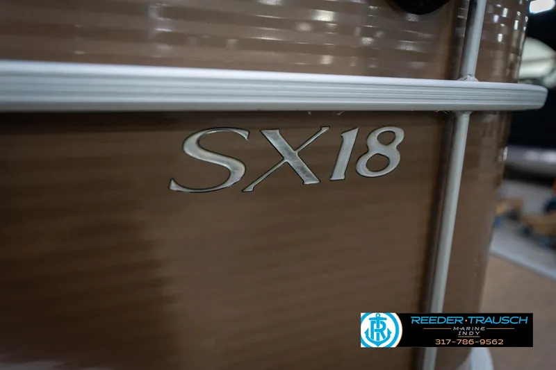 Slide: The Image of 2017 Bennington 18 SLX boat with SX18 emblem, Reeder-Trausch Marine logo visible. - 52
