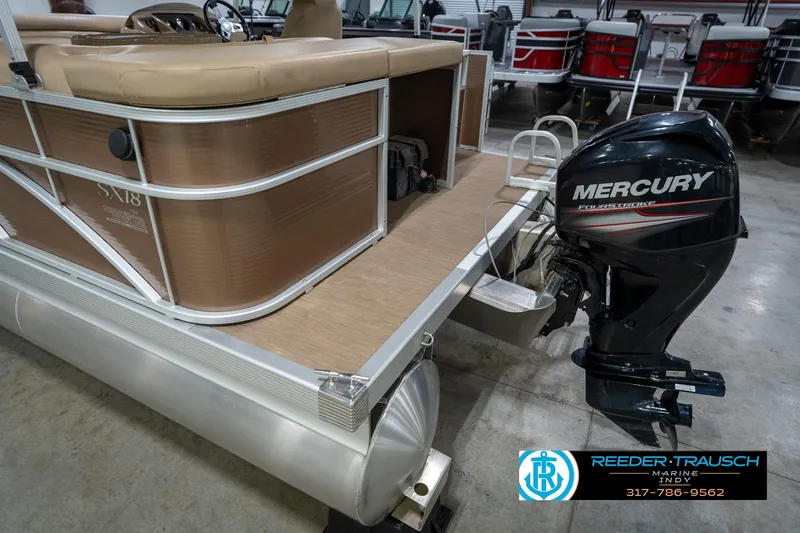 Slide: The Image of 2017 Bennington 18 SLX pontoon boat with Mercury FourStroke outboard motor in showroom. - 54