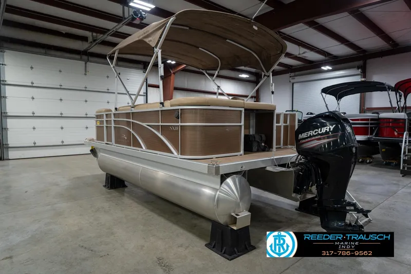 Slide: The Image of 2017 Bennington 18 SLX pontoon boat with Mercury outboard motor in a showroom. - 9