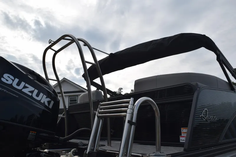 Slide: The Image of 2025 Qwest L-Class 822 RLS pontoon boat with Suzuki engine, featuring sleek design and sturdy ladder. - 10