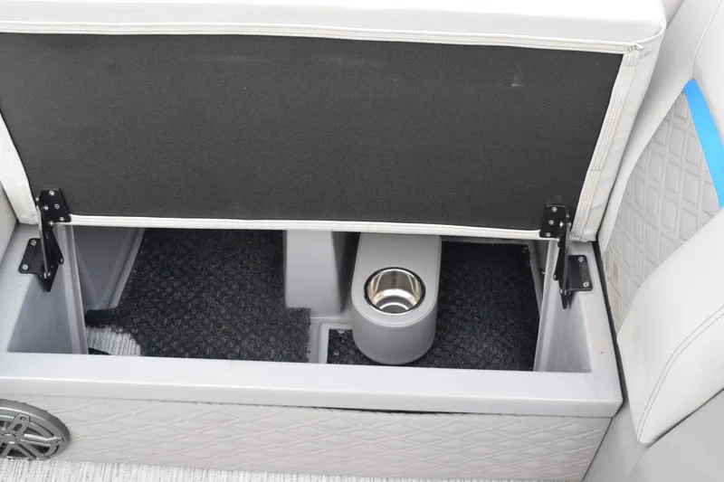 Slide: The Image of 2025 Qwest L-Class 822 RLS storage compartment with cup holder and carpeted interior. - 19