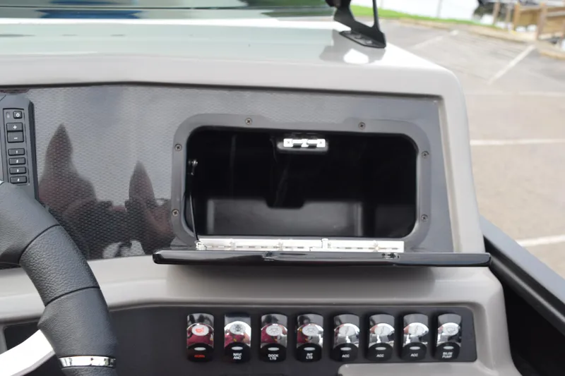 Slide: The Image of 2025 Qwest L-Class 822 RLS dashboard with open storage compartment and control panel. - 29