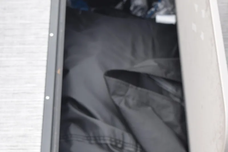 Slide: The Image of Storage compartment in 2025 Qwest L-Class 822 RLS boat, featuring black interior. - 35