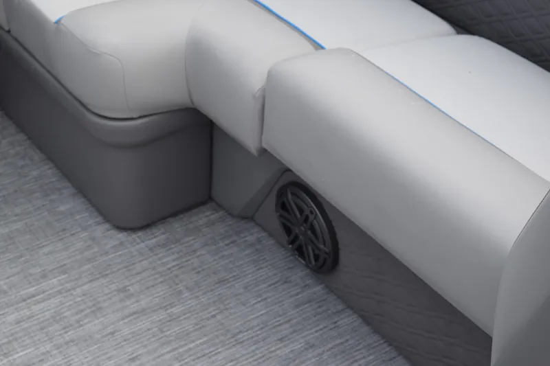 Slide: The Image of 2025 Qwest L-Class 822 RLS boat interior with gray seating and speaker detail. - 38