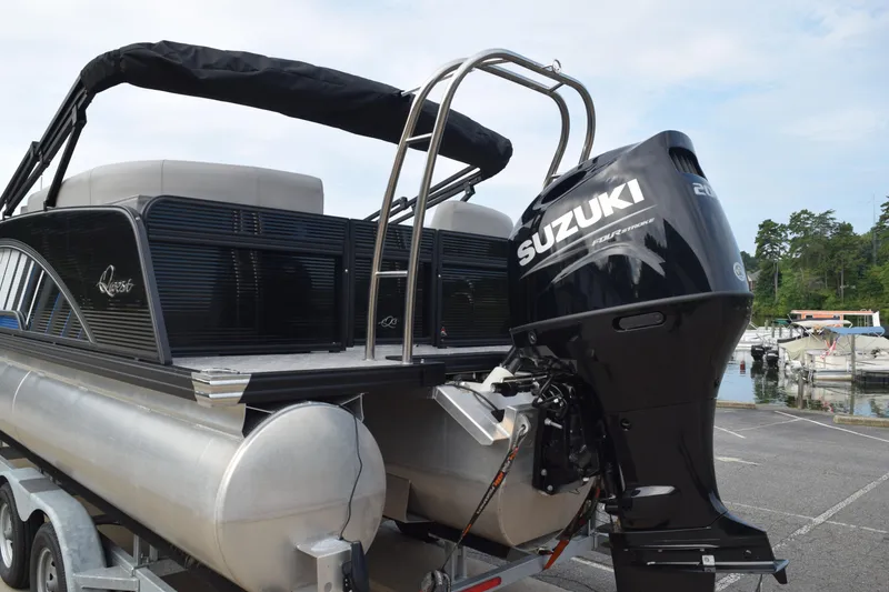 Slide: The Image of 2025 Qwest L-Class 822 RLS pontoon boat with Suzuki outboard motor at marina. - 4