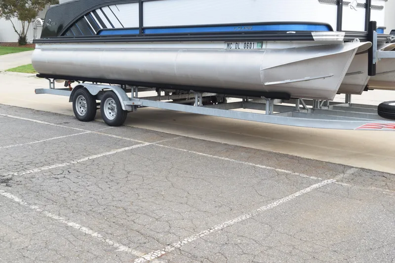 Slide: The Image of 2025 Qwest L-Class 822 RLS pontoon boat on trailer in parking lot. - 42