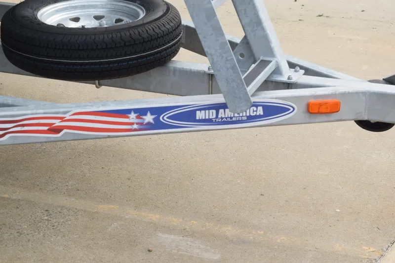 Slide: The Image of Trailer hitch with American flag design and "Mid America Trailers" logo, 2025 Qwest L-Class 822 RLS. - 43