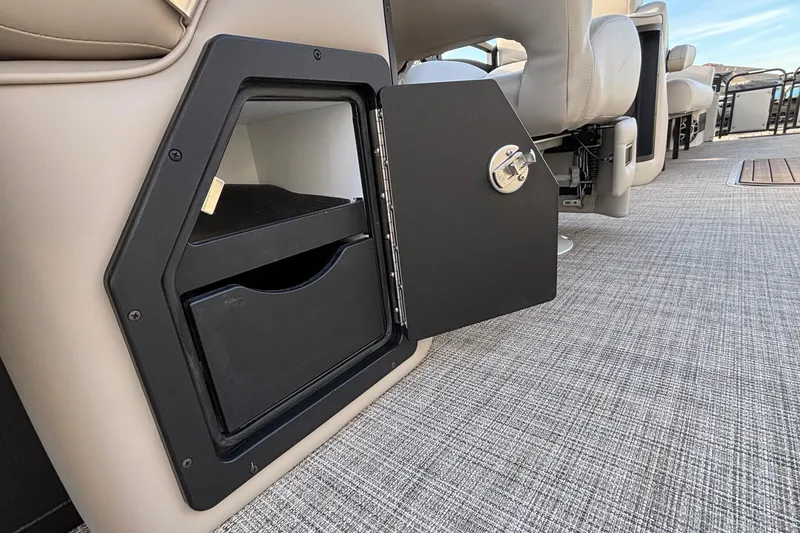 Slide: The Image of 2026 JC Neptoon 25TT Sport interior storage compartment with open door and seating. - 17