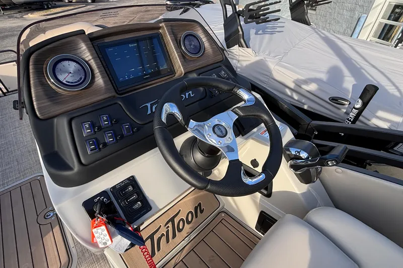 Slide: The Image of 2026 JC Neptoon 25TT Sport boat dashboard with steering wheel and control panel. - 22