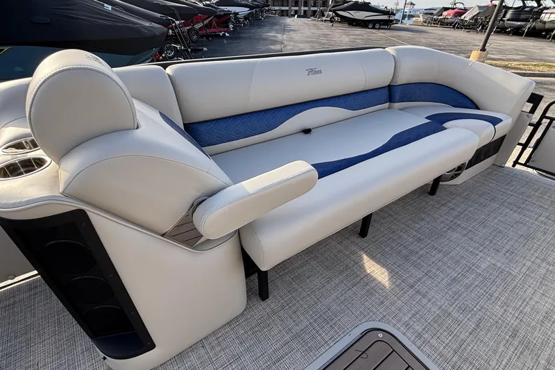 Slide: The Image of Luxurious seating on 2026 JC Neptoon 25TT Sport pontoon boat, featuring elegant blue and white upholstery. - 25