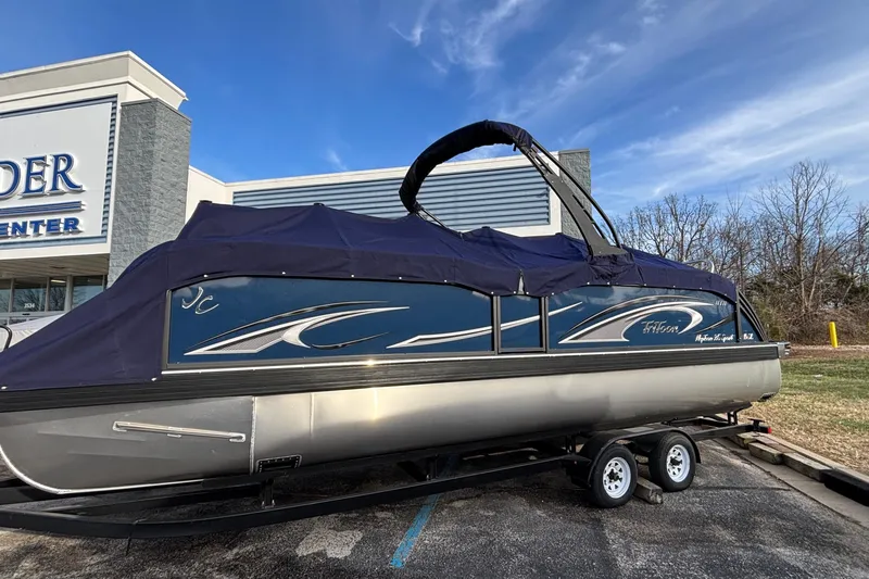 Slide: The Image of 2026 JC Neptoon 25TT Sport pontoon boat with cover on trailer, parked outside dealership. - 41