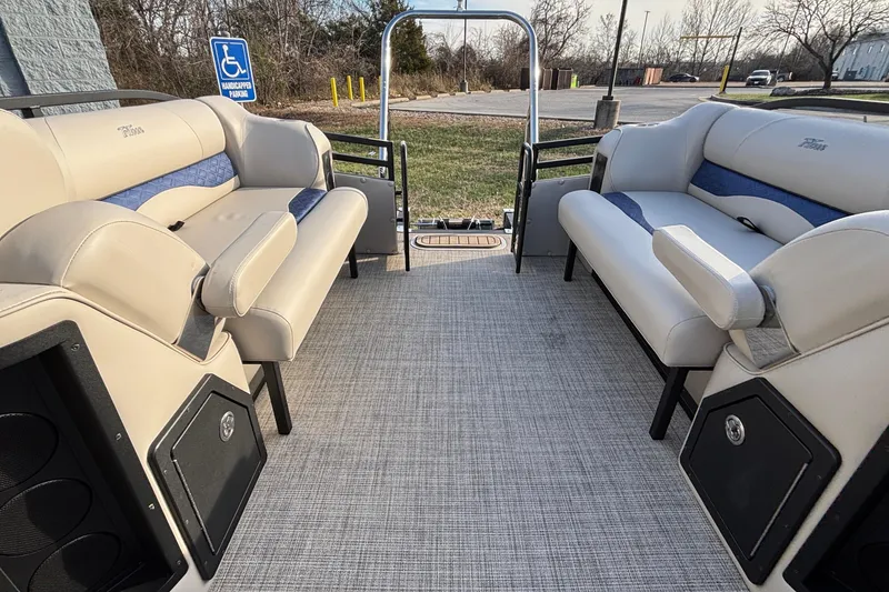 Slide: The Image of 2026 JC Neptoon 25TT Sport pontoon boat interior with beige seating and blue accents. - 10