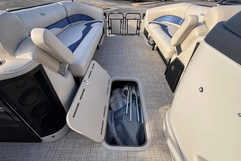 Slide: The Image of 2026 JC Neptoon 25TT Sport interior with open storage compartment and luxurious seating. - 38