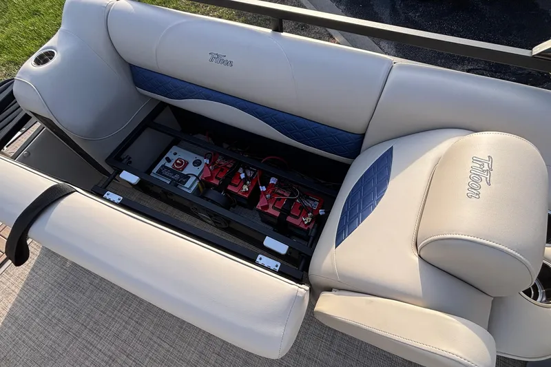 Slide: The Image of 2026 JC Neptoon 25TT Sport boat seat with battery storage compartment open. - 7
