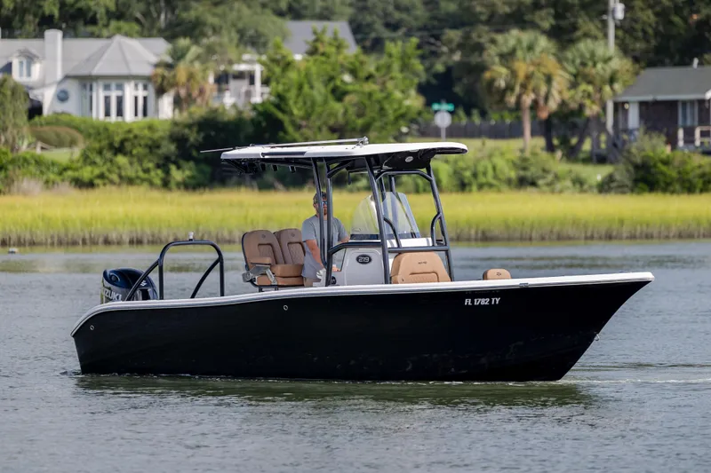 Slide: The Image of 2023 Sea Pro 219 Deep V CC boat cruising on a scenic waterway. - 2