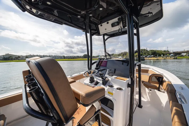Slide: The Image of 2023 Sea Pro 219 Deep V CC boat interior with helm, seating, and water view. - 20
