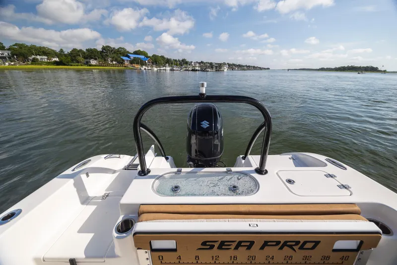 Slide: The Image of 2023 Sea Pro 219 Deep V CC boat on calm water, scenic shoreline view. - 26
