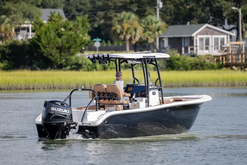 Slide: The Image of 2023 Sea Pro 219 Deep V CC boat cruising on a calm river with lush greenery. - 3