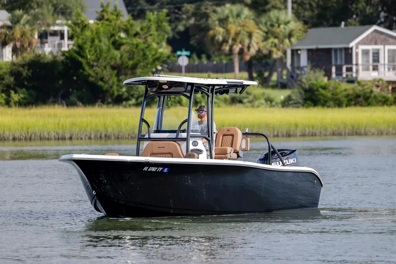 Slide: The Image of 2023 Sea Pro 219 Deep V CC boat cruising on a calm waterway. - 5