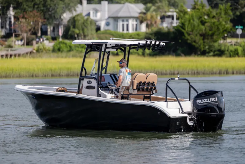 Slide: The Image of 2023 Sea Pro 219 Deep V CC boat cruising on a calm river with lush greenery. - 8
