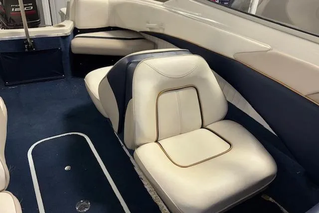 Slide: The Image of Interior of a 1996 Bayliner 1700 LS boat with white and blue seating. - 11