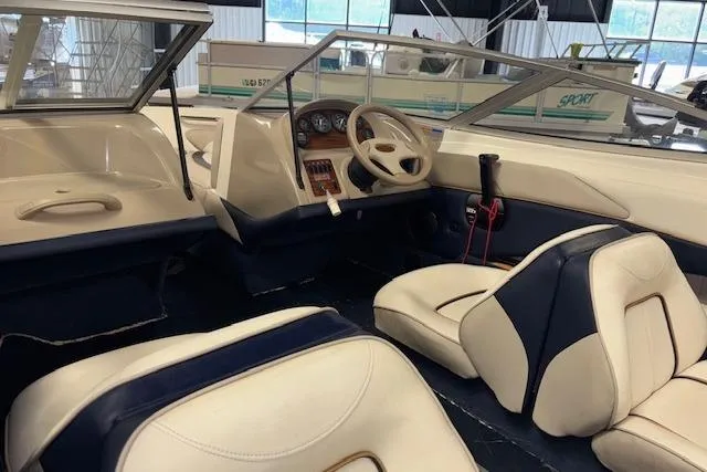 Slide: The Image of Interior of a 1996 Bayliner 1700 LS boat with white and navy seating. - 15
