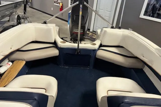 Slide: The Image of Interior of a 1996 Bayliner 1700 LS boat with white seating and blue accents. - 16
