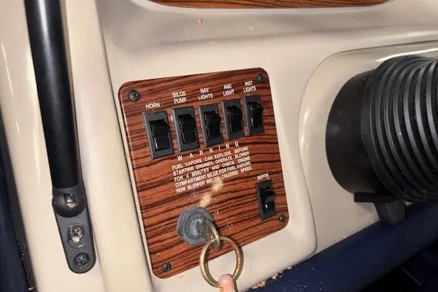 Slide: The Image of Control panel of a 1996 Bayliner 1700 LS boat with switches and key ignition. - 19