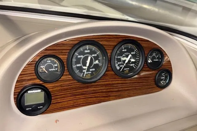 Slide: The Image of Dashboard of 1996 Bayliner 1700 LS boat with wood panel and gauges. - 20