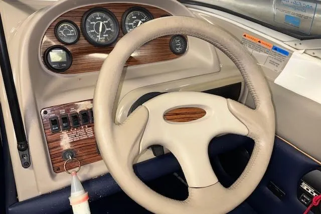 Slide: The Image of 1996 Bayliner 1700 LS boat dashboard with steering wheel and instrument panel. - 21