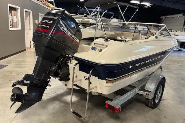 Slide: The Image of 1996 Bayliner 1700 LS boat on trailer with Force 120 outboard motor in a showroom. - 4