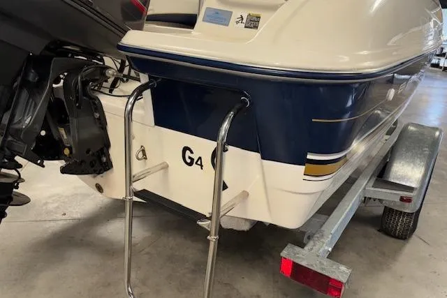 Slide: The Image of 1996 Bayliner 1700 LS boat on trailer, rear view with ladder and motor. - 5