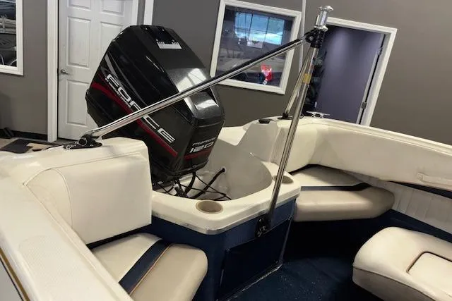 Slide: The Image of 1996 Bayliner 1700 LS boat interior with Force outboard motor, white seating, and blue accents. - 8