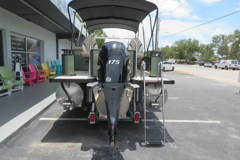 Slide: The Image of 2026 Avalon 2385 Venture 85 Rear Fish luxury tri-toon boat in Sarasota, FL parking lot. - 2