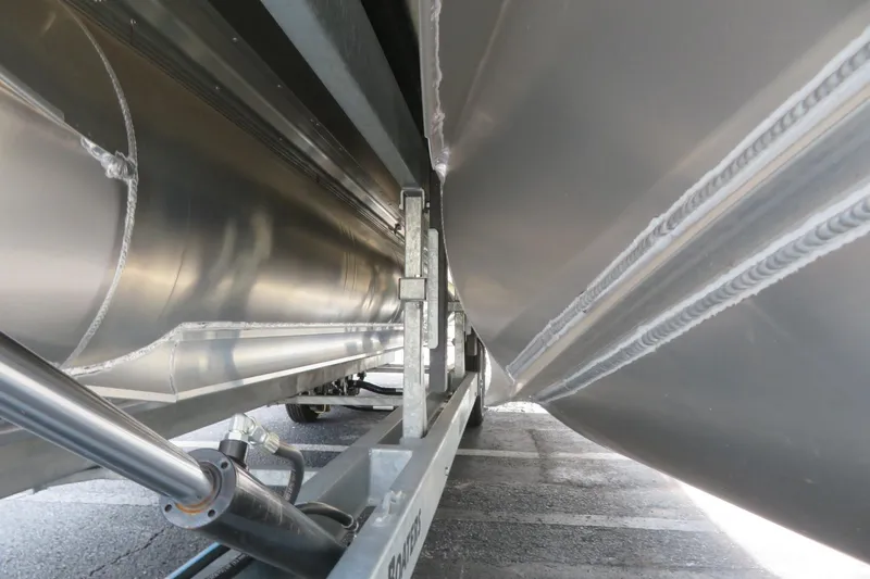 Slide: The Image of Close-up of 2026 Avalon 2385 Venture 85 Tri-toon undercarriage, showcasing sleek metal construction. - 44