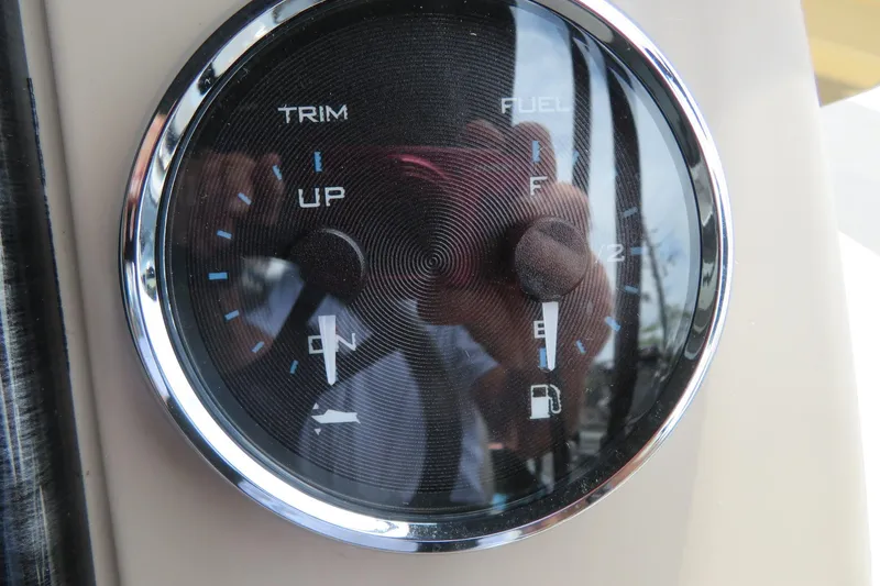 Slide: The Image of Close-up of a 2026 Avalon 2385 Venture boat fuel and trim gauge. - 72