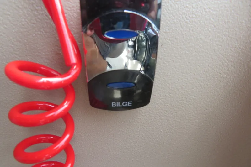 Slide: The Image of Red coiled cord and bilge switch on Avalon 2385 Venture 85 boat, 2026 model. - 74